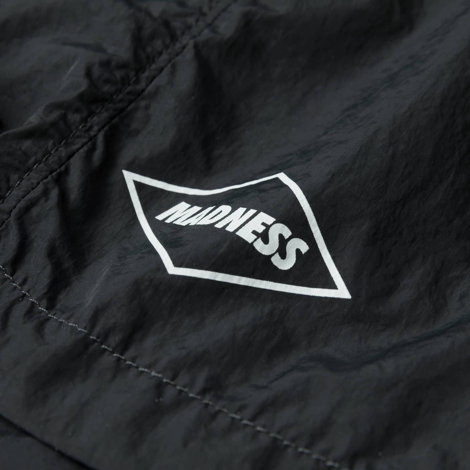 MADNESS LOGO NYLON SHORTS
